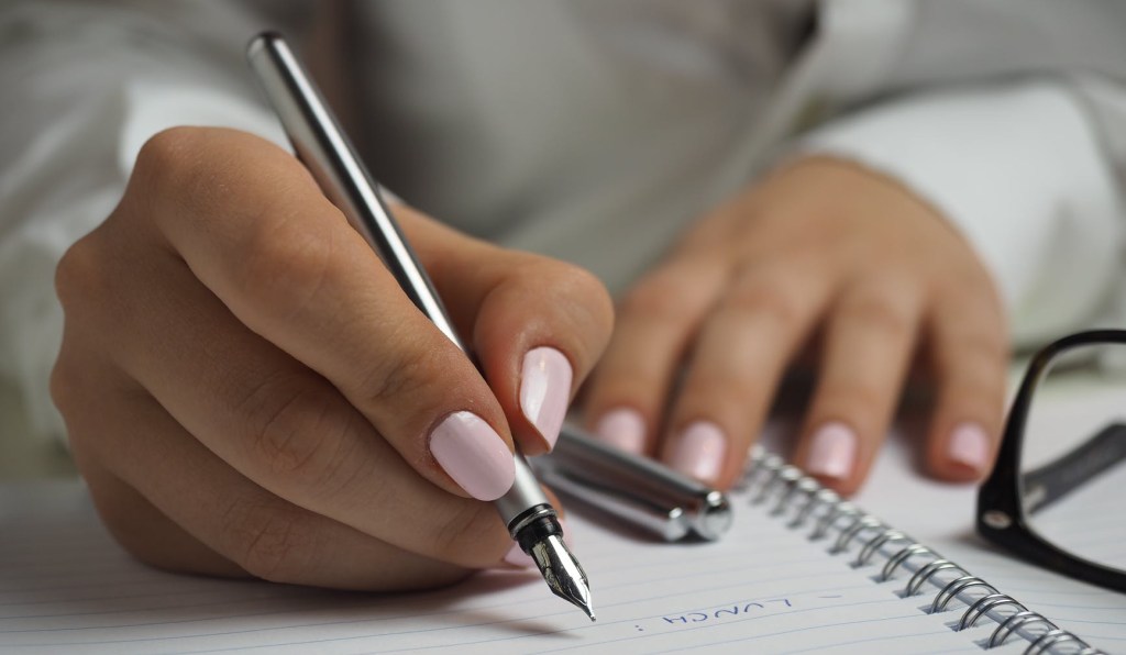 A woman writing with a fountain pen.